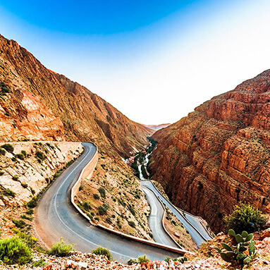 Moroccan road weaving through brown mountainsides.