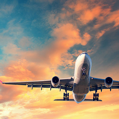 A plane flying through orange clouds with a scenic view