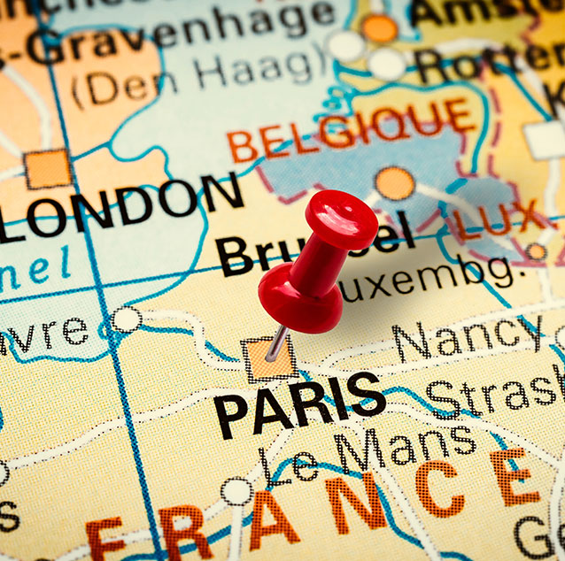 World map with a red pin on Paris.