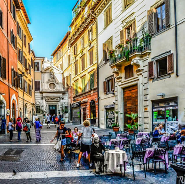 People and restaurants at a small square in Rome.