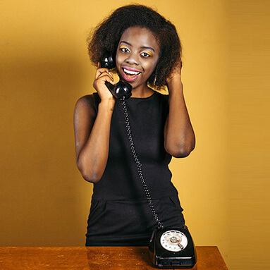 Woman smiling while picking up phone call