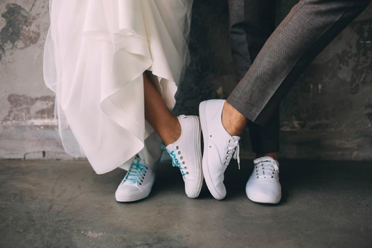 A married couple wearing white sneakers