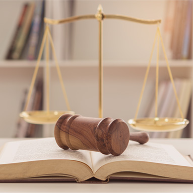 Gavel on book with weighted scale in background | History of Law for all | Hippo.co.za partner