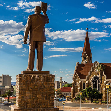 German Lutheran church in Windhoek with a statue and blue skies