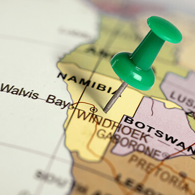 Map of Namibia with green drawing pin stuck to Namibia.